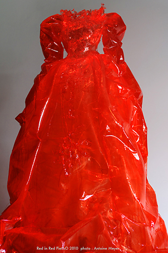 Piet.sO Red in Red, Baba yaga, sculpture of a big transparent and luminous red dress, visual arts.
