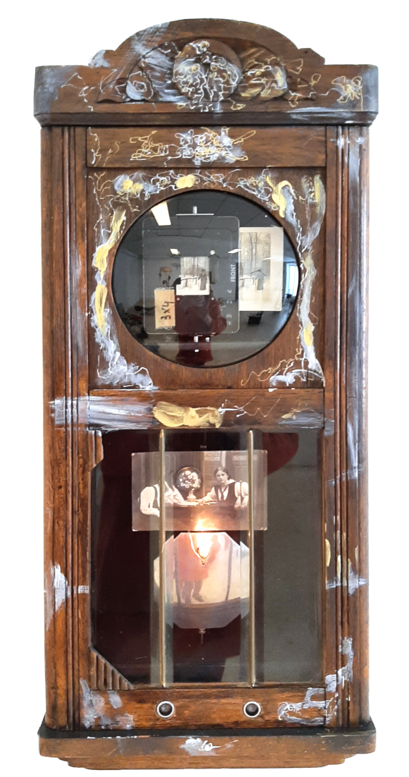 Ding, Composite sculpture, case clock with photograpies and figurines, ringing when the public approach , contemporary sculture and installation artist Piet.sO. 