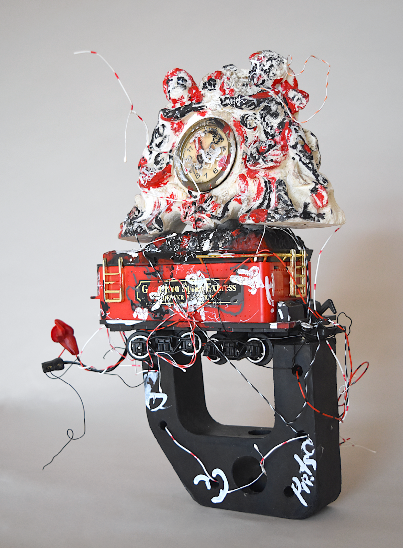  contemporary composite sculpture with a decorative clock and a toy coal trolley. art and time